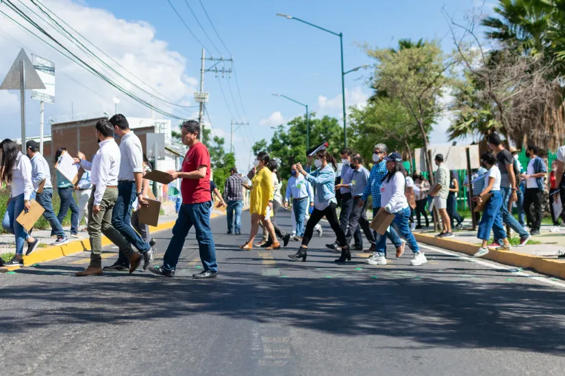 Pessoas atravessam a rua em seu bairro em León, México.