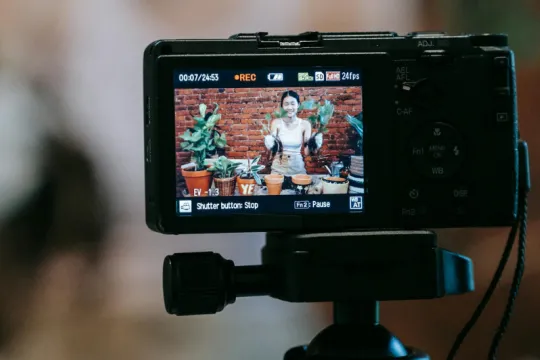 A woman is filmed showing her plants in pots