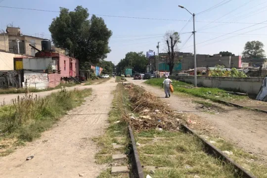 A man walks along railroad tracks 