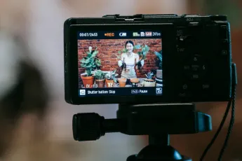 A woman is filmed showing her plants in pots