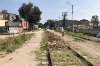 A man walks along railroad tracks 