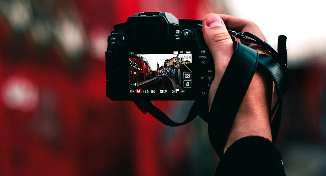 Photograph of camera with viewscreen showing picture of a city
